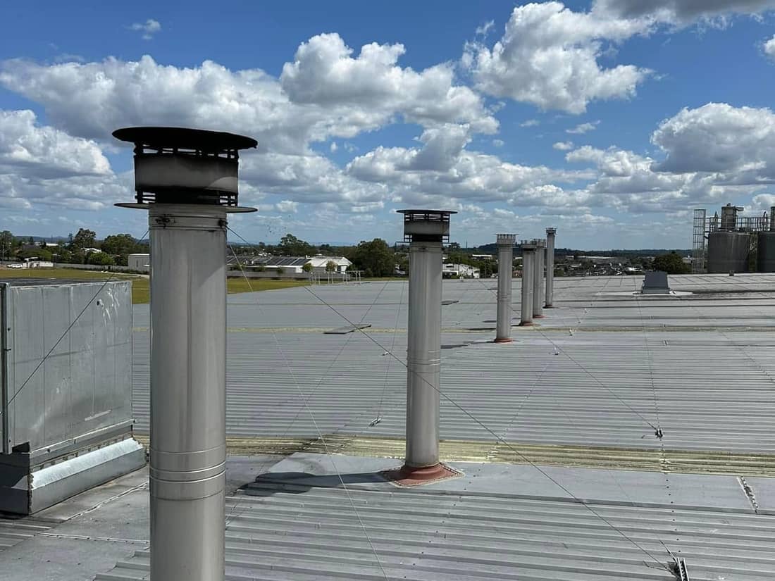 Flues on a commercial rooftop, serviced on site
